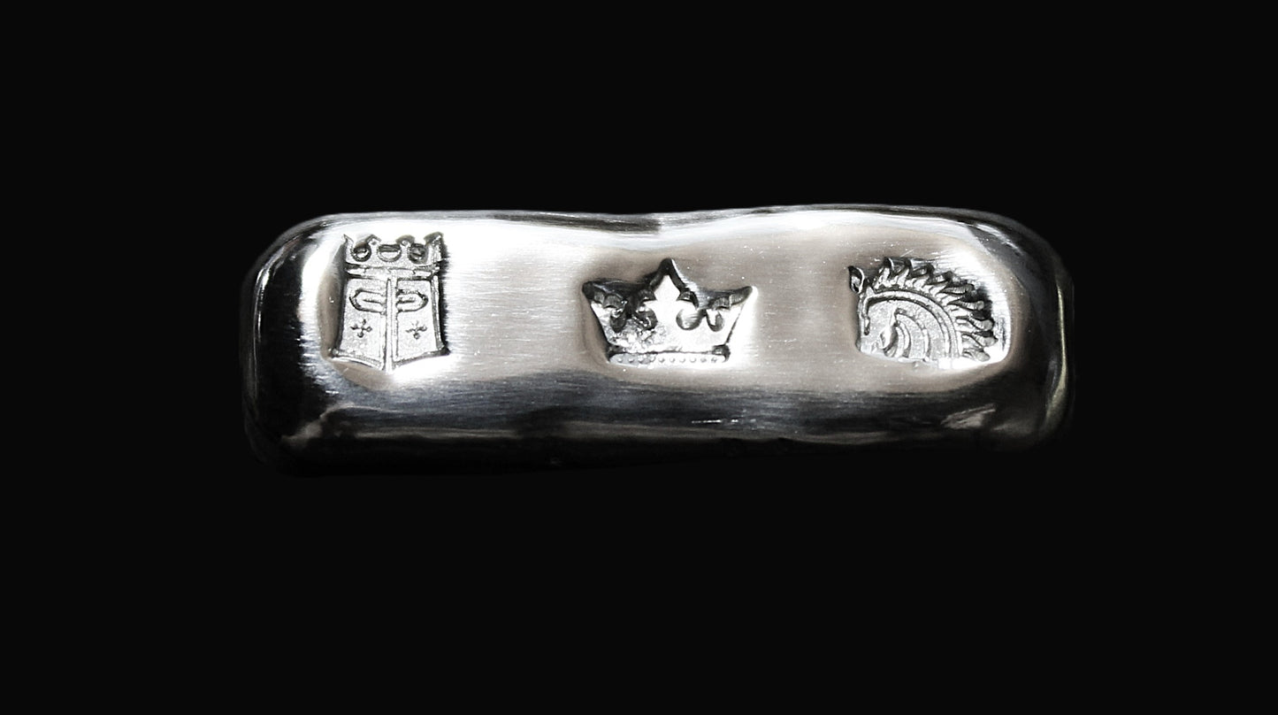 15g Hand-Poured Fine Silver Kit Kat Bar crafted in Tasmania, featuring a stamped Medieval King's helmet, a Crown and a horse. Finished with a beautiful high polish highlighting its unique hand-poured textures. Part of an exclusive bullion weight range, overpoured to exceed its stamped weight for added value. Ready for immediate dispatch with secure tracked shipping.
