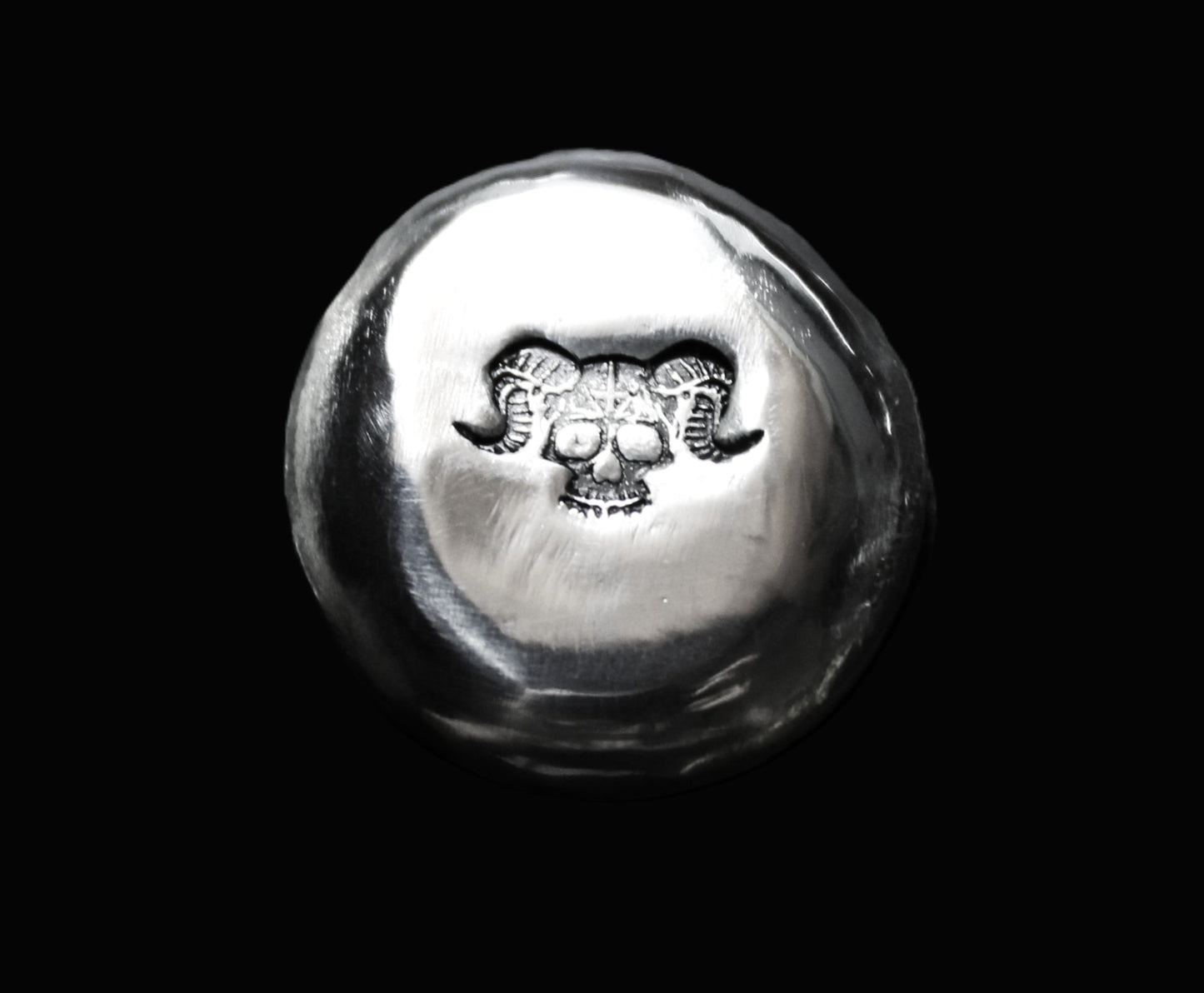 Close-up view of the Baphomet Mythology stamp on a 15g hand-poured fine round silver bar. The high-polish surface reflects light, highlighting the handcrafted quality of this premium bullion piece from the Tasmanian Bullion Company