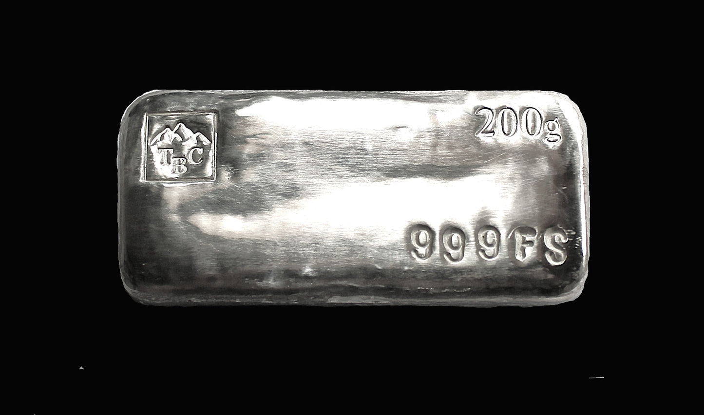 Front-facing close up view of a 200g hand-poured fine silver bullion bar, featuring a bold black patina finish. The top left corner showcases a large mountain logo, the top right displays a prominent 200g marking, and the bottom right features a deep-stamped 999FS purity stamp. The high-polish surface highlights its handcrafted quality, making it a premium investment piece from the Tasmanian Bullion Company