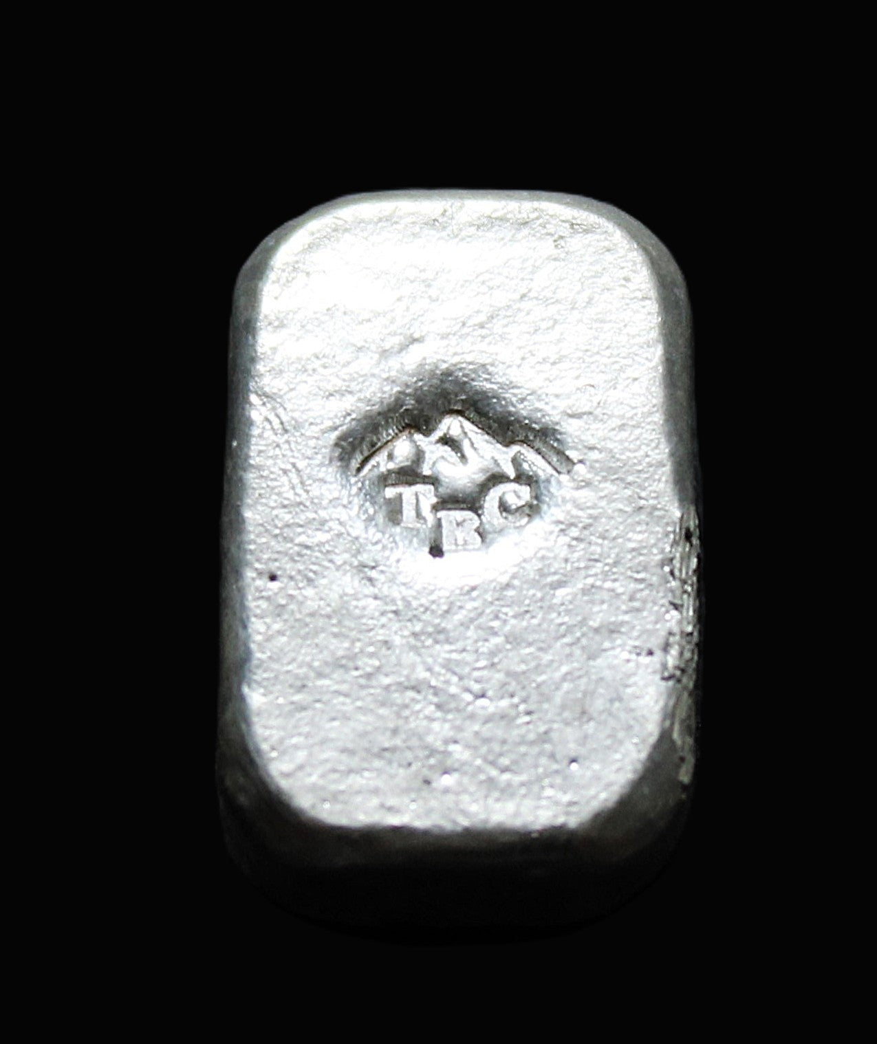 Back view of a 10g fine silver (999FS) bar, featuring a stamped TBC mountain range maker’s mark