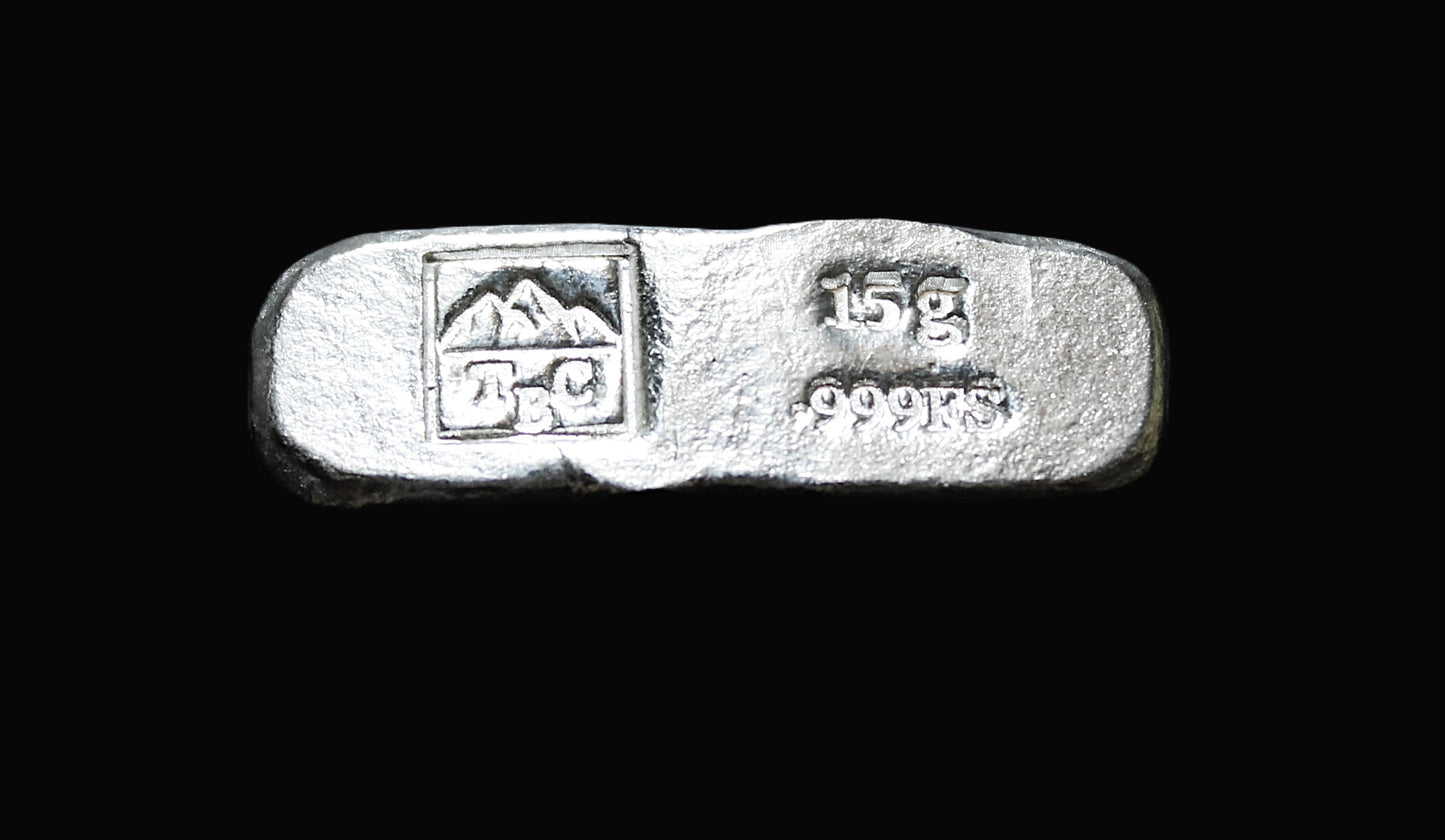 Reverse view of a 15g Hand-Poured Fine Silver Kit Kat Bar with our square makers mark and a stamp saying 15g .999FS. The surface retains its natural hand-poured texture, showcasing its raw and unique finish. Overpoured to exceed its stamped weight, ensuring added value. Part of an exclusive bullion weight range, crafted in Tasmania and ready for immediate dispatch with secure tracked shipping.