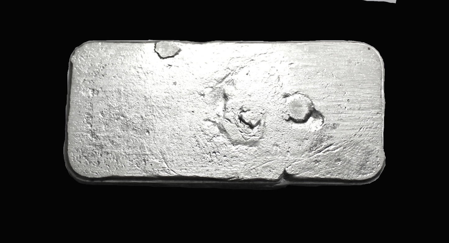 Underside view of a 200g hand-poured fine silver bullion bar, featuring a smooth, high-polish surface with no markings. The reflective finish highlights its handcrafted quality and unique pouring texture, making it a premium investment piece from the Tasmanian Bullion Company.