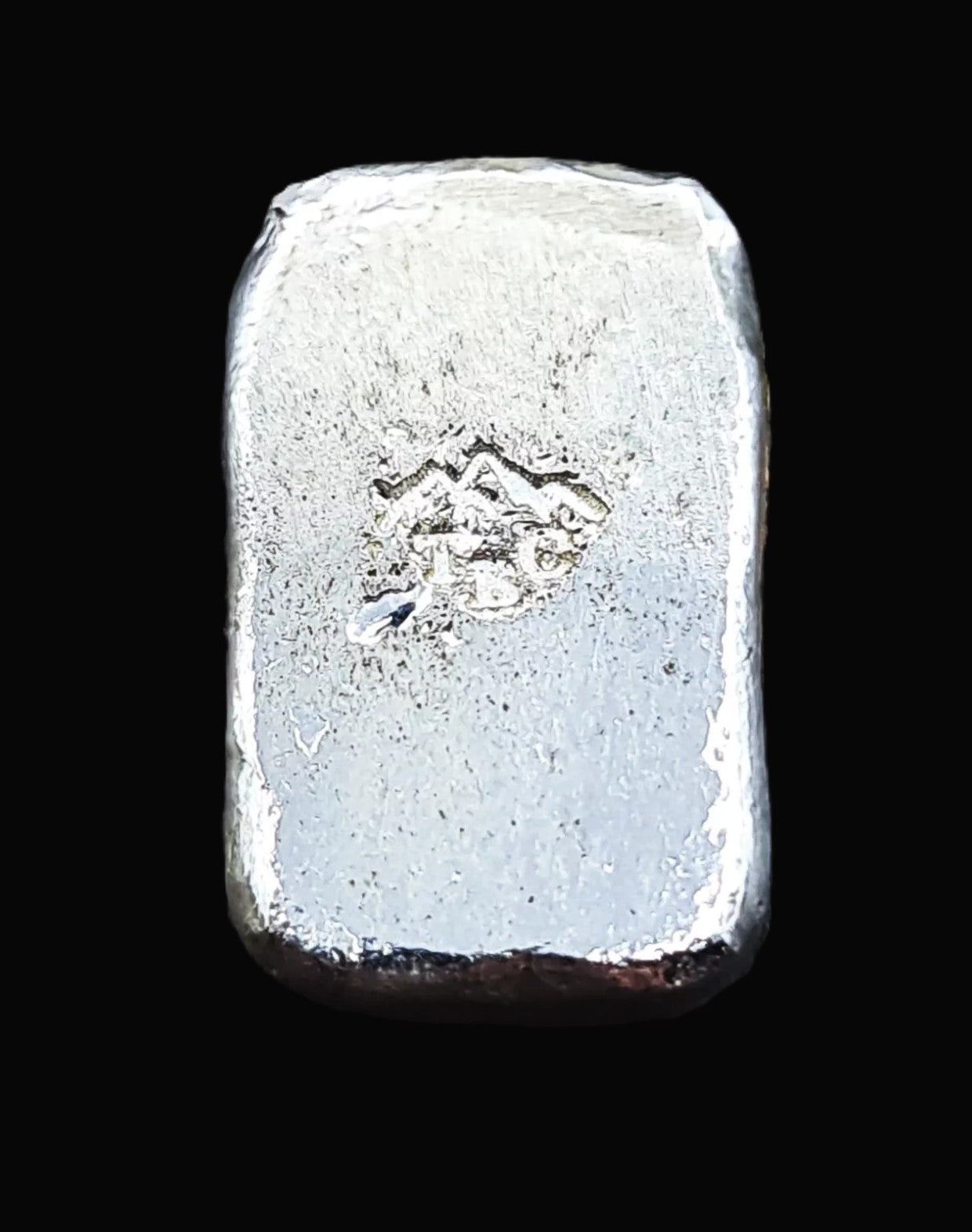 Back view of a 10g fine silver (999FS) bar, featuring a stamped TBC mountain range maker’s mark