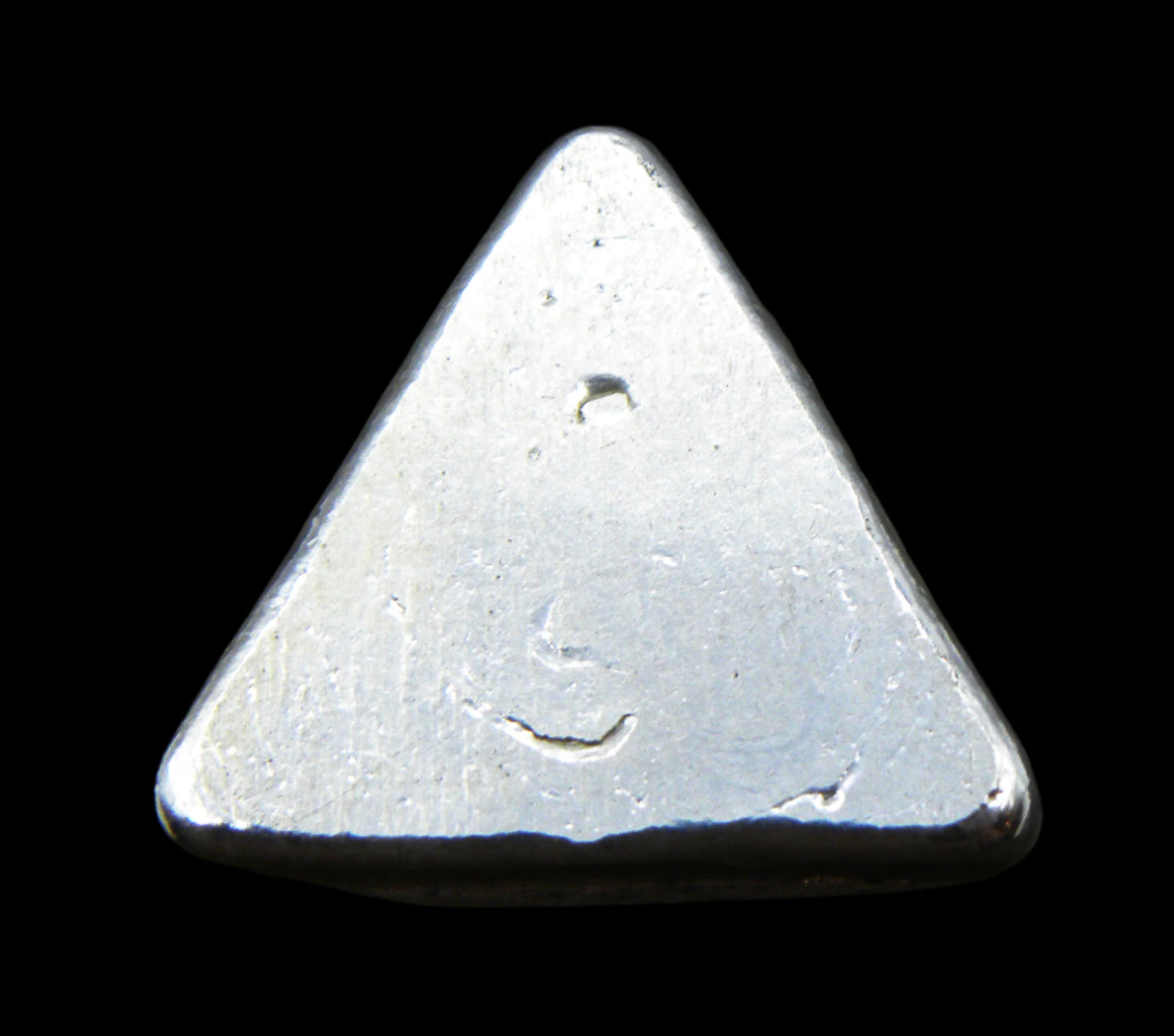 Close-up underside view of a 20g hand-poured triangular fine silver bullion bar, featuring a smooth, high-polish surface with no markings. The reflective finish highlights its handcrafted quality and unique pouring texture, making it a premium investment piece from the Tasmanian Bullion Company