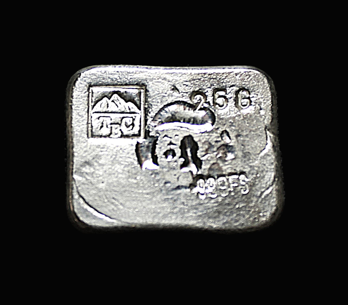Underside view of a 25g hand-poured fine silver bar, featuring our TBC makers mark stamp and a stamp reading 25g and 999FS. The smooth, surface reflects light, highlighting its handcrafted quality and unique pouring texture. A premium collectible from the Tasmanian Bullion Company