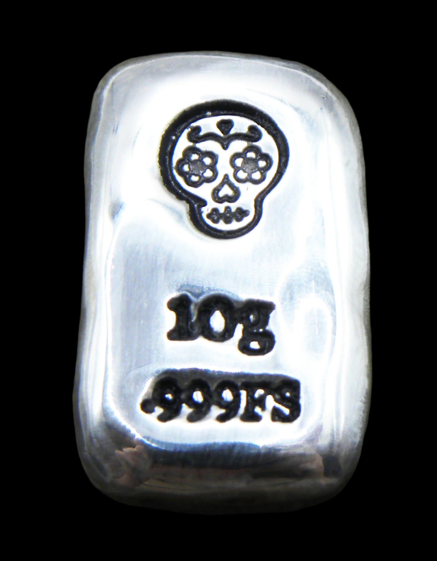 Close-up of a 10-gram 999 fine silver rectangular bar with a polished, reflective surface. The Sugar Skull stamp is stamped on the top half of the bar and 10g 999FS on the bottom half. The bar is positioned vertically.