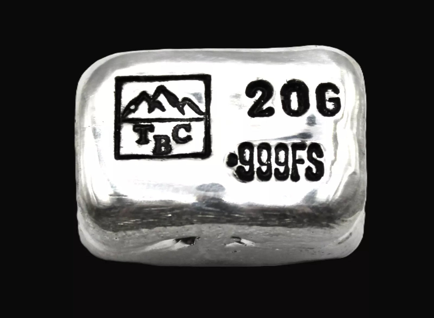 Close-up view of a 20g hand-poured fine silver bullion bar from Tasmanian Bullion Company, featuring prominent TBC and 999 stamps with black patina. The high-polish finish and smooth edges highlight its handcrafted quality and unique pouring process, making it a premium investment piece.