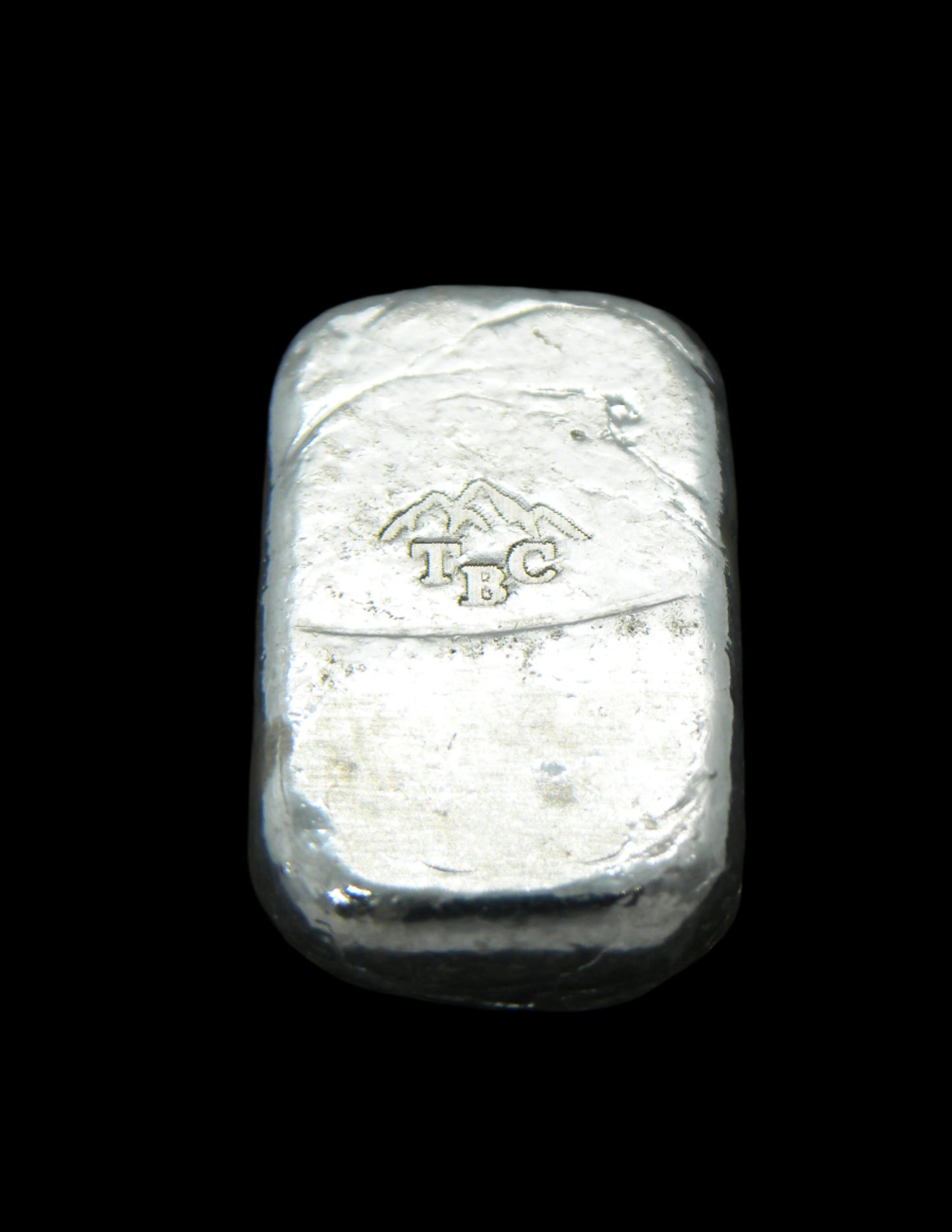 Back view of a 10g fine silver (999FS) bar, featuring a stamped TBC mountain range maker’s mark
