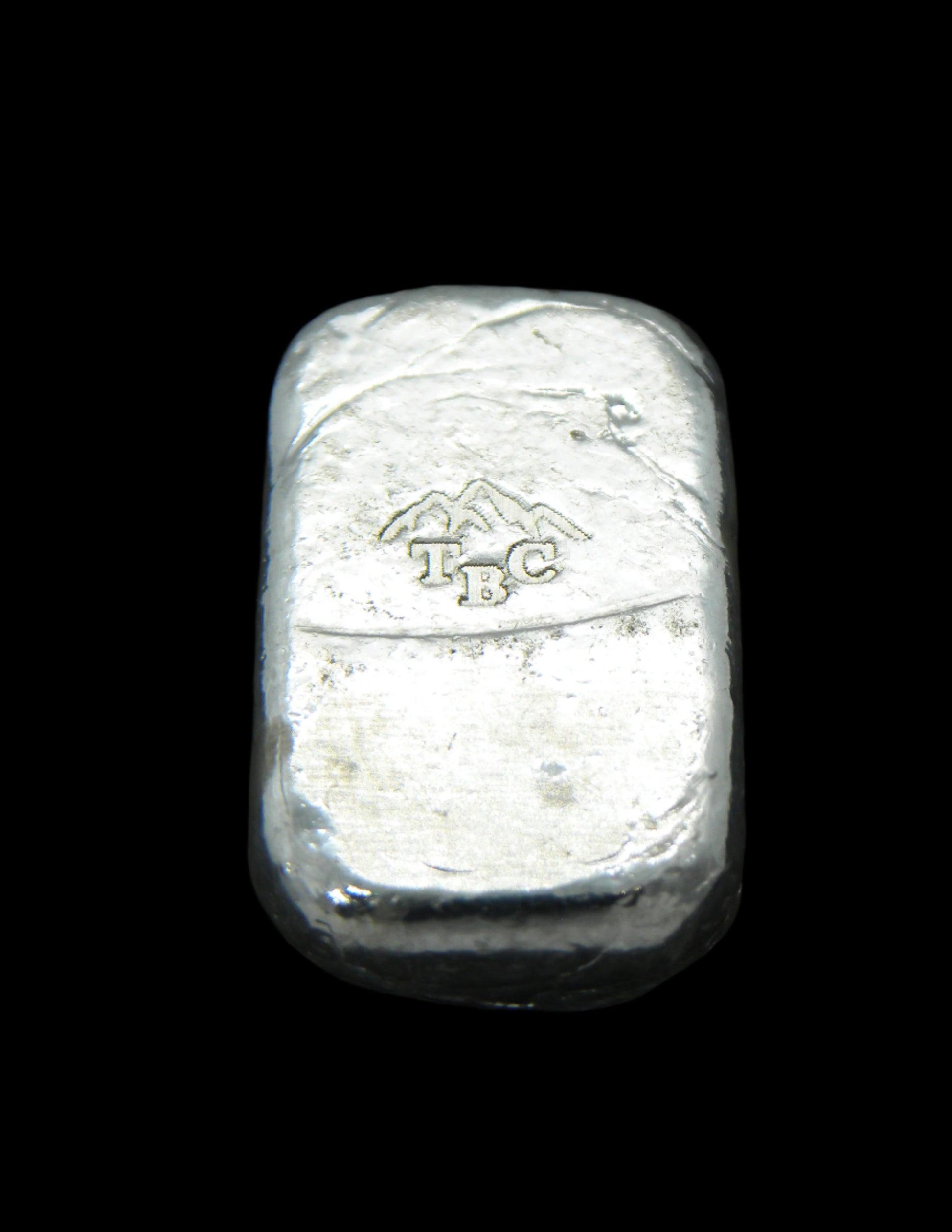 Back view of a 10g fine silver (999FS) bar, featuring a stamped TBC mountain range maker’s mark