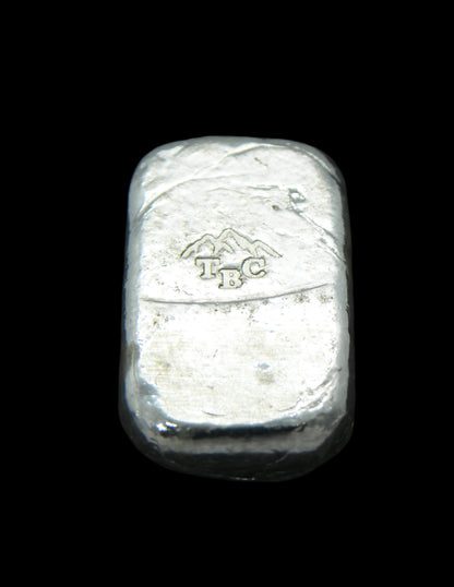 Back view of a 10g fine silver (999FS) bar, featuring a stamped TBC mountain range maker’s mark