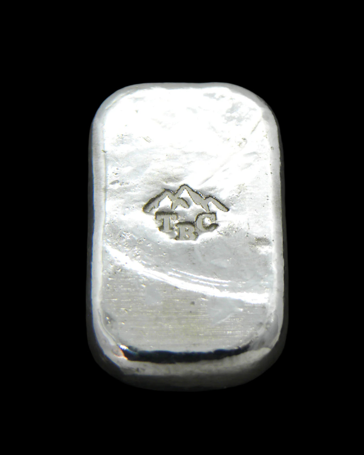 Back view of a 10g fine silver (999FS) bar, featuring a stamped TBC mountain range maker’s mark