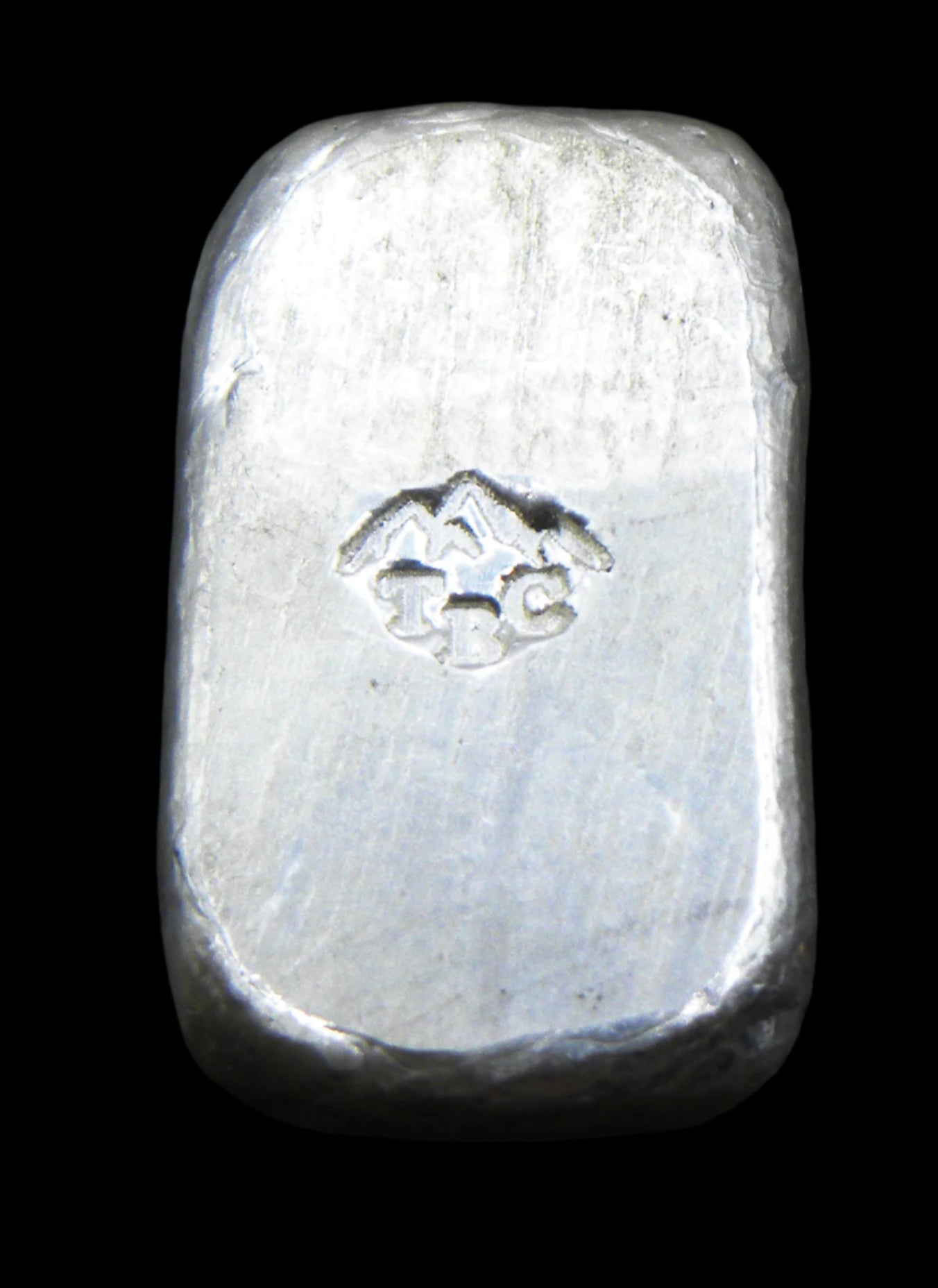 Back view of a 10g fine silver (999FS) bar, featuring a stamped TBC mountain range maker’s mark