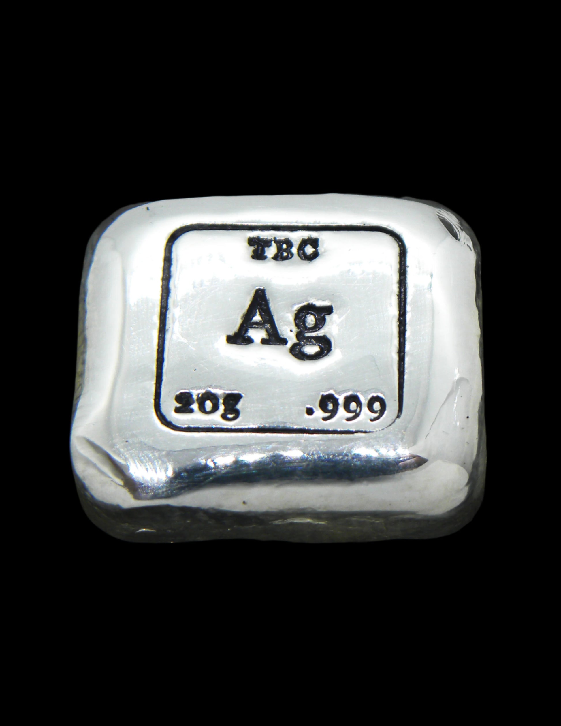 A 20g hand-poured fine silver bullion bar featuring bold TBC and 999 purity stamps with a deep black patina for enhanced contrast. The high-polish finish and soft edges highlight its handcrafted quality, while the unique pouring texture makes each piece one of a kind. A premium investment bullion from the Tasmanian Bullion Company.