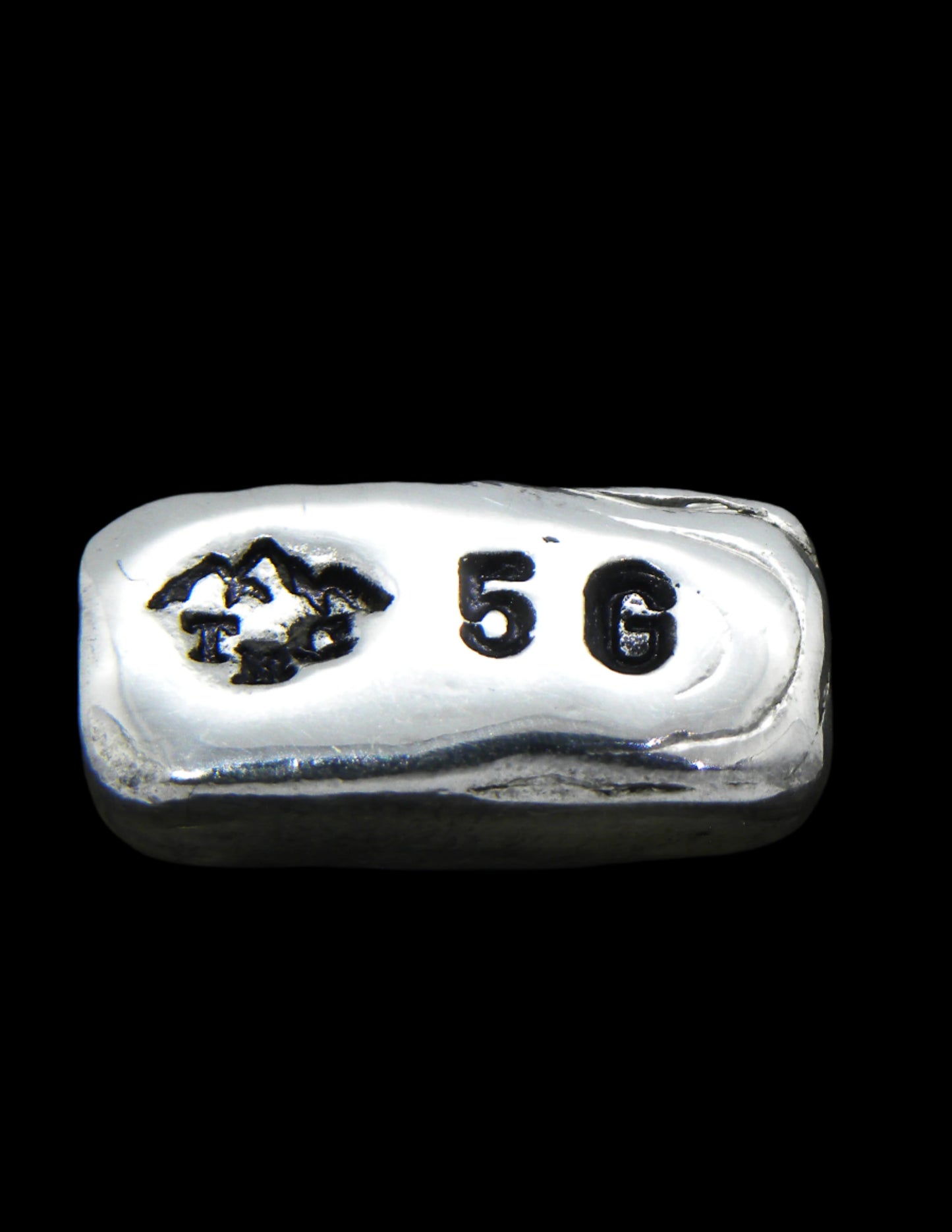 5g Hand-Poured Fine Silver Bar featuring a small mountain maker’s mark on the front and a .999FS purity stamp on the reverse. Finished with a black patina to highlight its unique hand-poured texture. Individually crafted in Tasmania, ensuring each piece is one of a kind. Overpoured to exceed the stamped weight and securely shipped with tracking