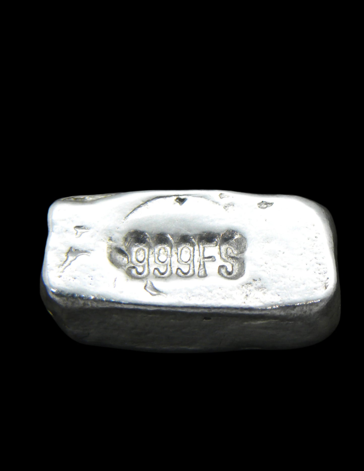 Reverse view of a 5g Hand-Poured Fine Silver Bar, showcasing a clearly stamped .999FS purity mark. The surface retains its unique hand-poured texture, enhanced by a black patina finish. Each bar is individually crafted in Tasmania, ensuring no two pieces are identical.